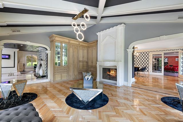 362 Keswick Rd, Bloomfield Hills, MI 48304 - living room featuring visible vents, a fireplace, beamed ceiling, ornate columns, and arched walkways