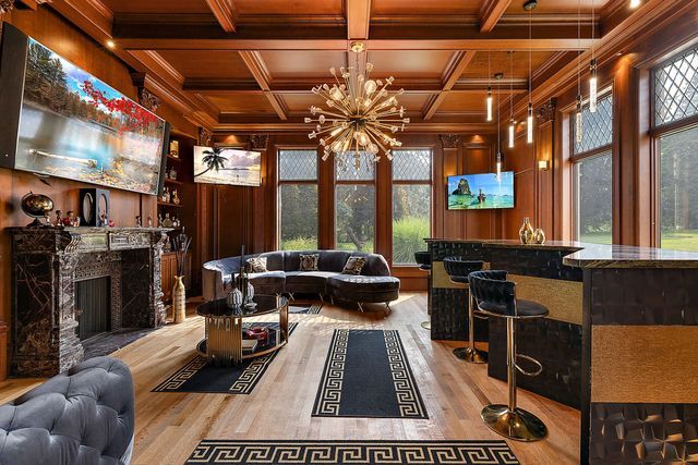 362 Keswick Rd, Bloomfield Hills, MI 48304 - living room featuring an inviting chandelier, plenty of natural light, and wood finished floors