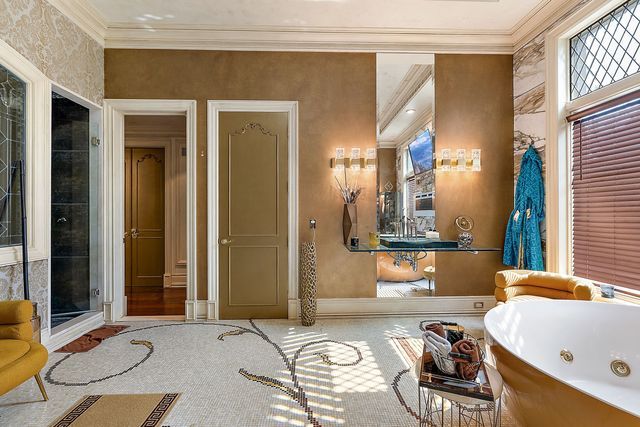 362 Keswick Rd, Bloomfield Hills, MI 48304 - full bath with baseboards, ornamental molding, a soaking tub, and a shower stall