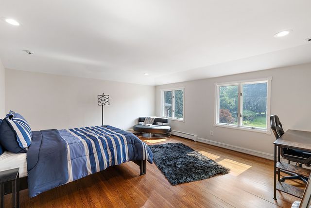 362 Keswick Rd, Bloomfield Hills, MI 48304 - bedroom featuring baseboards, recessed lighting, wood finished floors, and baseboard heating