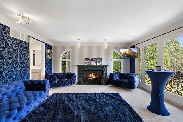 362 Keswick Rd, Bloomfield Hills, MI 48304 - living area with carpet flooring, crown molding, wallpapered walls, and a high end fireplace