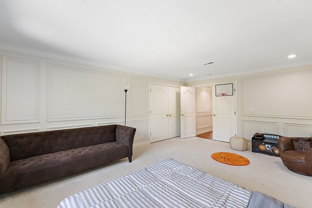 362 Keswick Rd, Bloomfield Hills, MI 48304 - living room with light colored carpet, ornamental molding, a decorative wall, and recessed lighting
