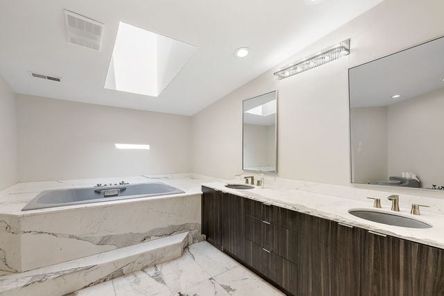362 Keswick Rd, Bloomfield Hills, MI 48304 - bathroom featuring a skylight, a sink, marble finish floor, and a garden tub