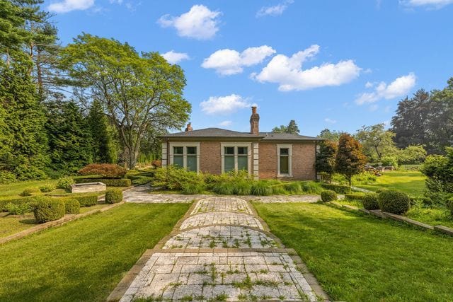 362 Keswick Rd, Bloomfield Hills, MI 48304 - rear view of property with a lawn, brick siding, and a chimney