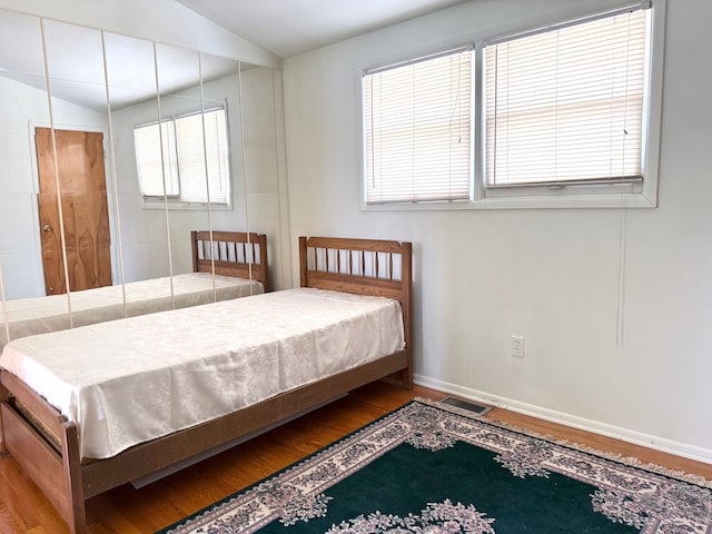 1536 W 13 Mile Rd, Madison Heights, MI 48071 - bedroom featuring baseboards, vaulted ceiling, wood finished floors, and visible vents