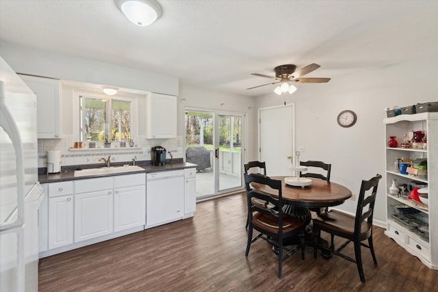 dining room featuring a ceiling fan and dark wood-type flooring