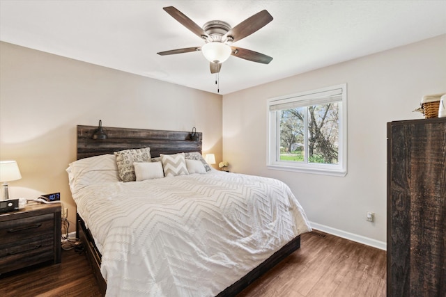 bedroom with baseboards, ceiling fan, and wood finished floors