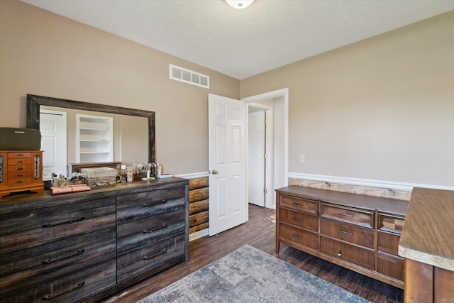 bedroom featuring dark wood finished floors and visible vents