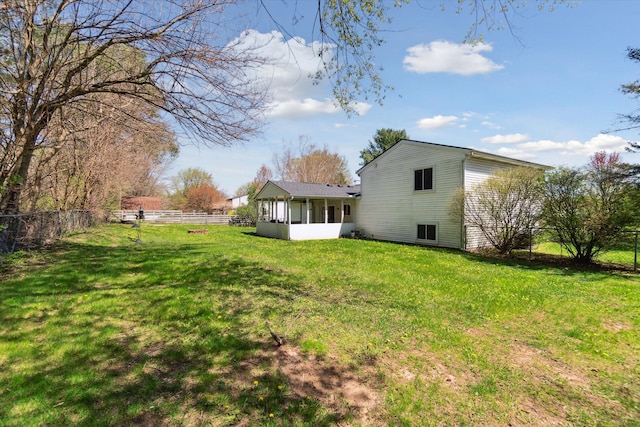 view of yard featuring a fenced backyard and a sunroom