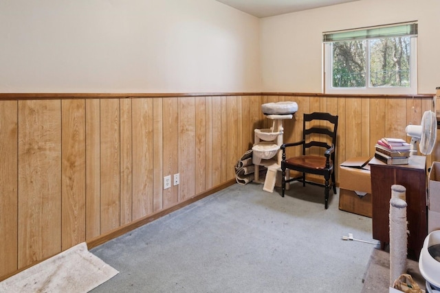 living area with wood walls and wainscoting