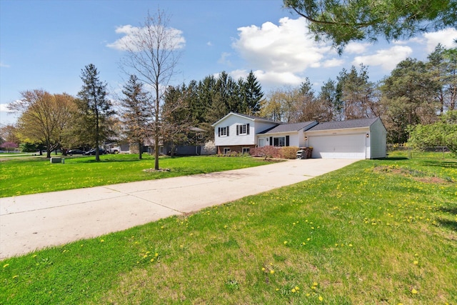 tri-level home featuring a garage, driveway, brick siding, and a front yard