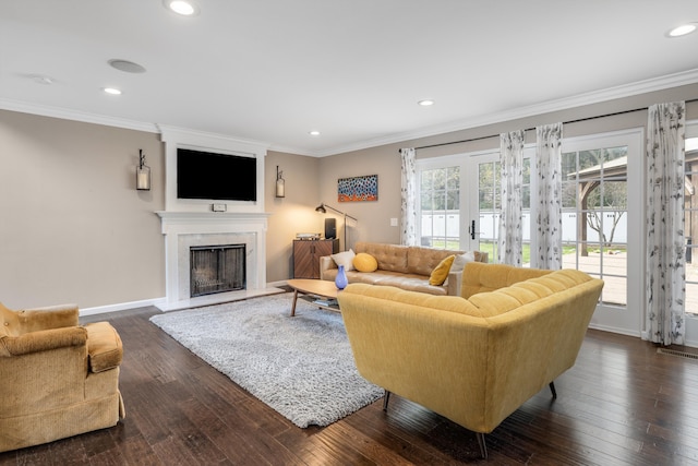 living room featuring crown molding, baseboards, a fireplace, and recessed lighting