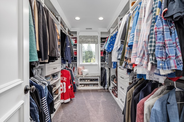 spacious closet with dark carpet and visible vents