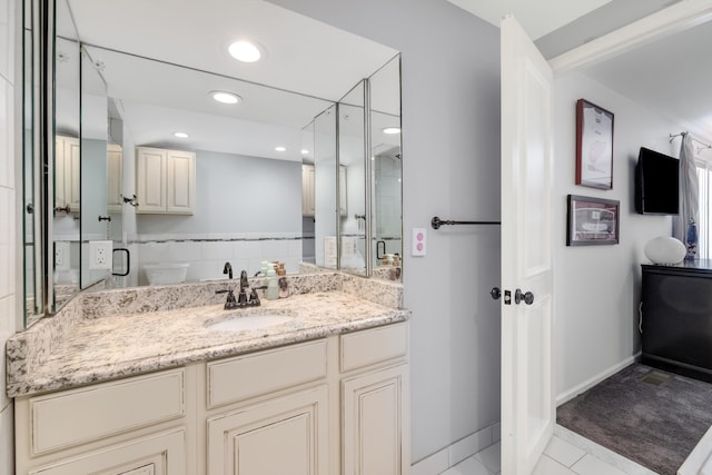 bathroom with vanity, baseboards, recessed lighting, tile patterned floors, and a stall shower