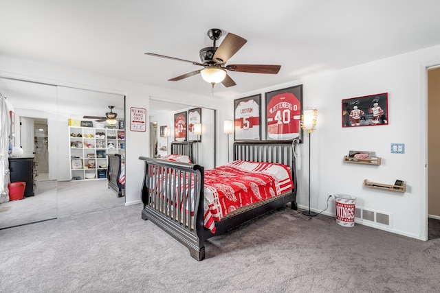 carpeted bedroom with a ceiling fan, baseboards, and visible vents