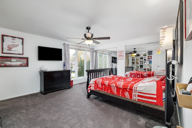 carpeted bedroom featuring a ceiling fan and multiple closets