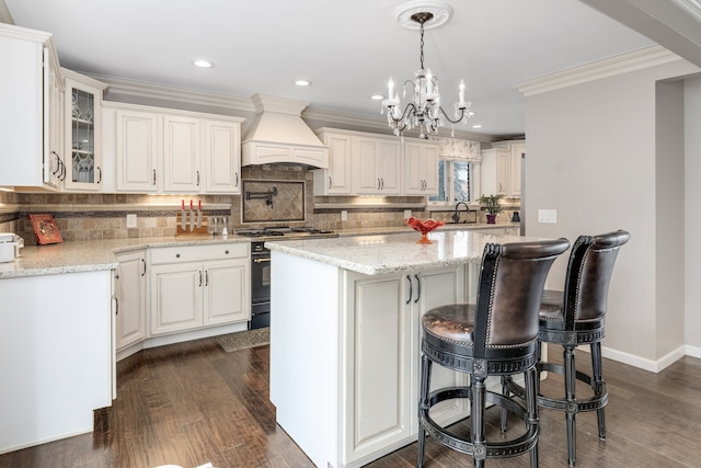 kitchen featuring backsplash, crown molding, custom range hood, and high end stove