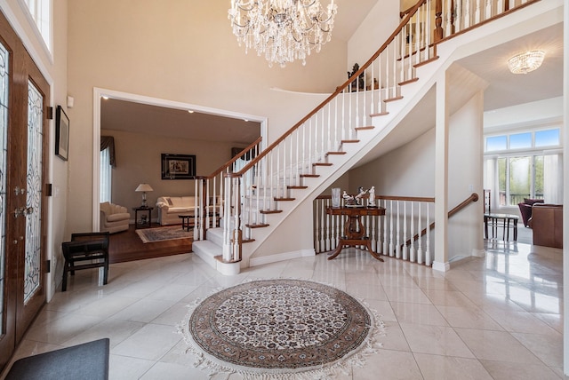 2832 Croftshire Ct, Rochester, MI 48306 - tiled foyer entrance with baseboards, stairs, a towering ceiling, and a notable chandelier