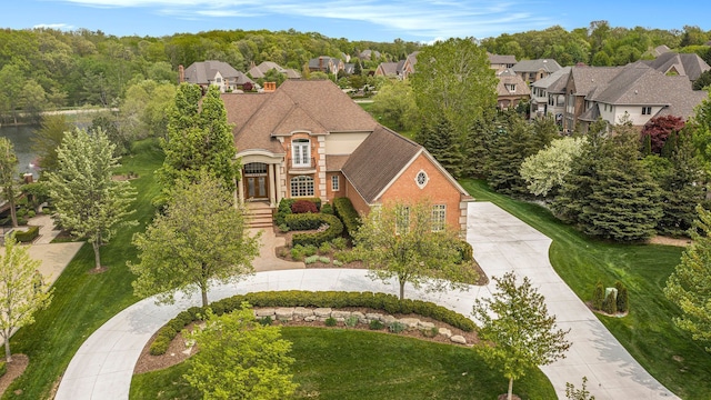 2832 Croftshire Ct, Rochester, MI 48306 - french provincial home featuring brick siding, a residential view, and concrete driveway