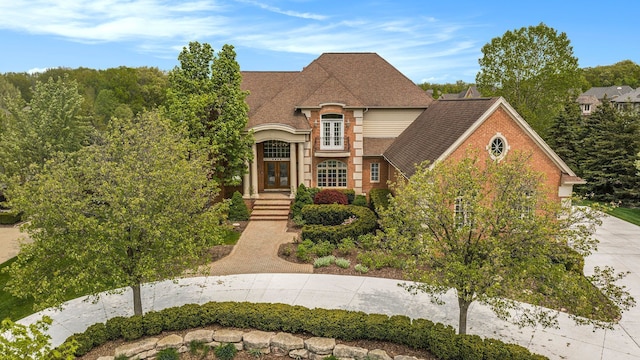 2832 Croftshire Ct, Rochester, MI 48306 - french provincial home with french doors, driveway, and a shingled roof