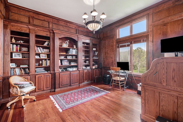 2832 Croftshire Ct, Rochester, MI 48306 - office area with ornamental molding, built in features, wooden walls, a chandelier, and light wood finished floors