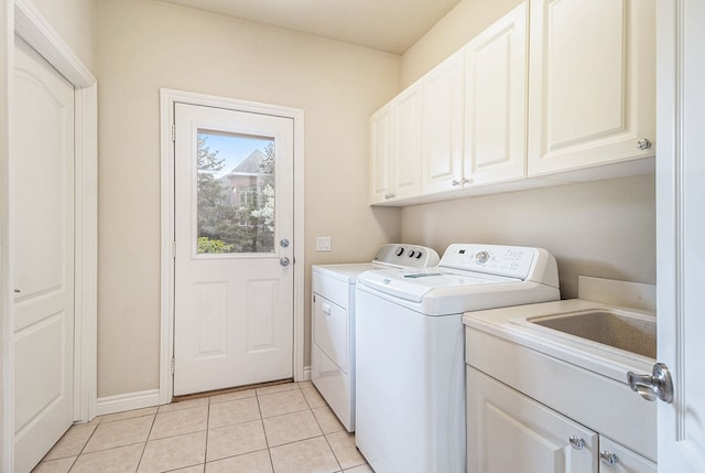 2832 Croftshire Ct, Rochester, MI 48306 - washroom featuring light tile patterned floors, baseboards, cabinet space, and washer and dryer
