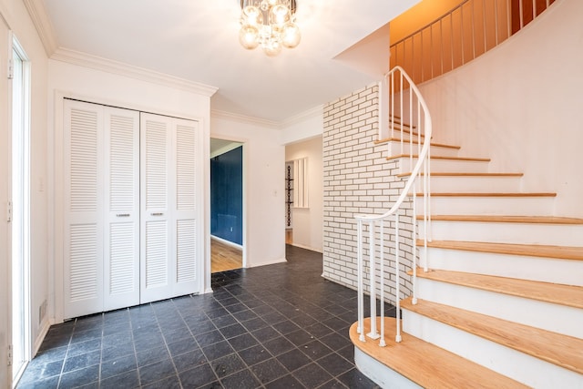 staircase featuring a chandelier, ornamental molding, baseboards, and stone finish flooring