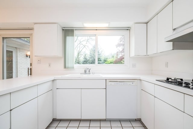 kitchen with white dishwasher, a sink, cooktop, and healthy amount of natural light
