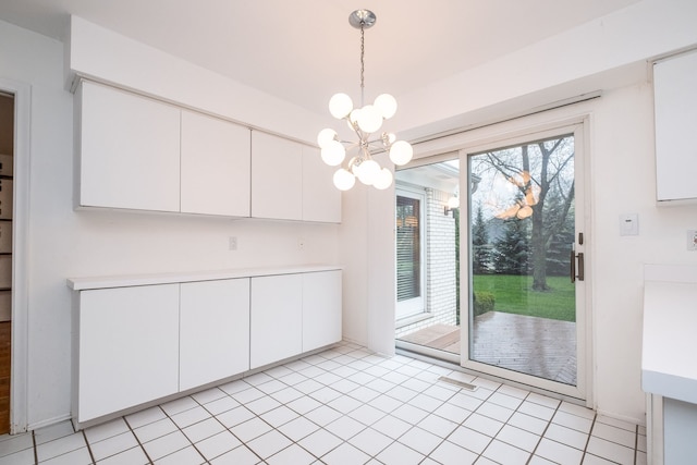 unfurnished dining area with a chandelier and light tile patterned floors