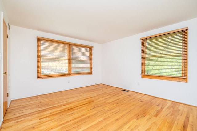 unfurnished room with wood finished floors