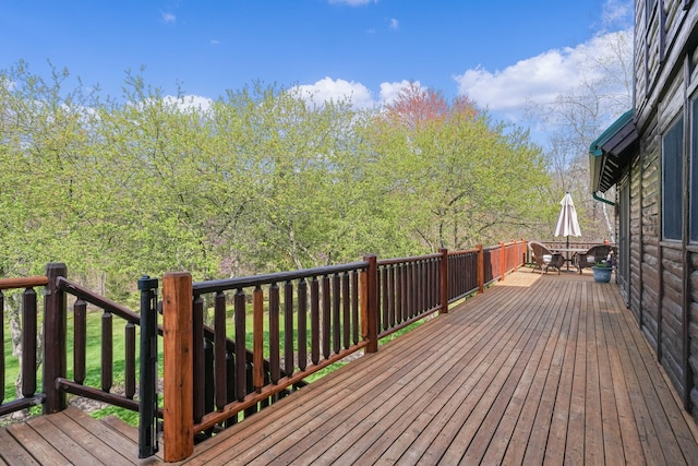 wooden terrace featuring outdoor dining area