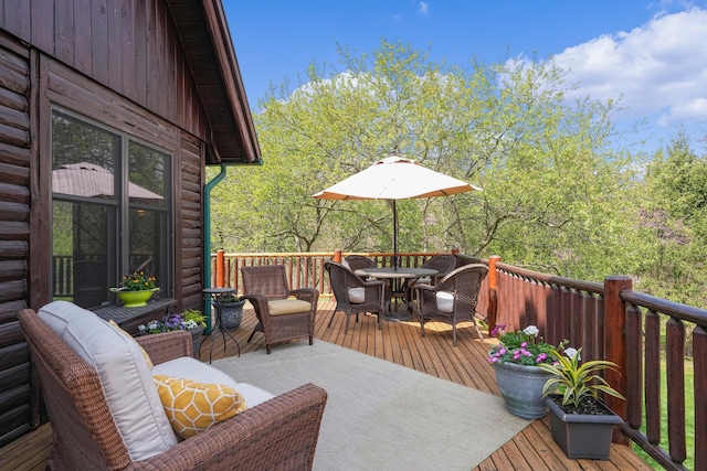 wooden terrace with outdoor dining space