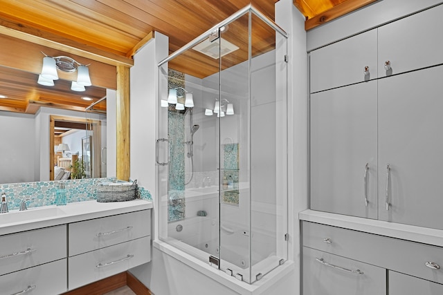 full bathroom featuring vanity and bath / shower combo with glass door