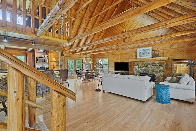living area featuring wooden ceiling, beamed ceiling, hardwood / wood-style flooring, and high vaulted ceiling