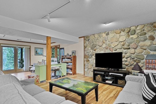 living room featuring baseboards, track lighting, and light wood finished floors