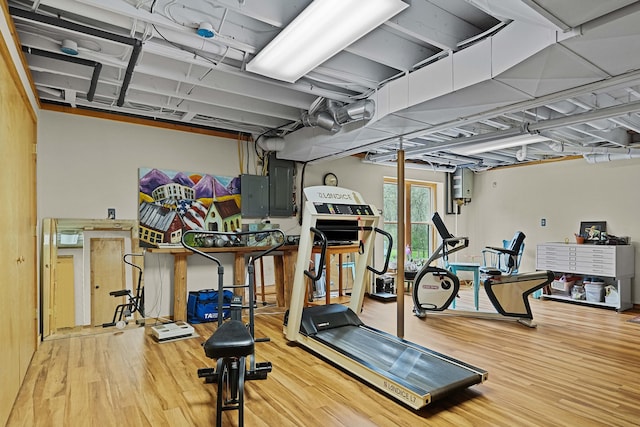 exercise area featuring wood finished floors and electric panel