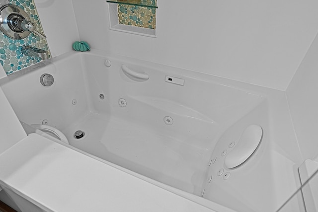 interior space with a tub with jets