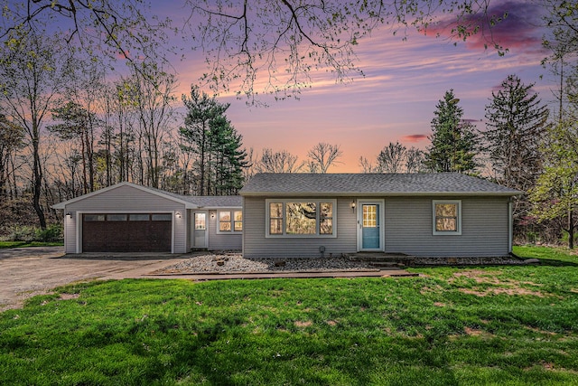 single story home with an attached garage, driveway, and a front yard
