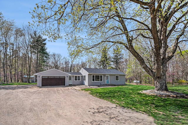 single story home with an attached garage, driveway, and a front yard