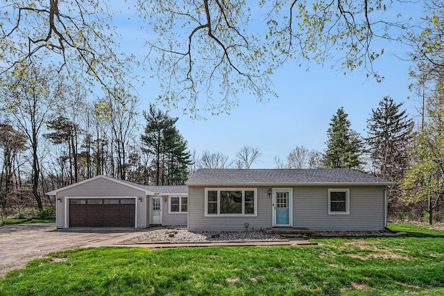 view of front of house with a garage, driveway, and a front yard