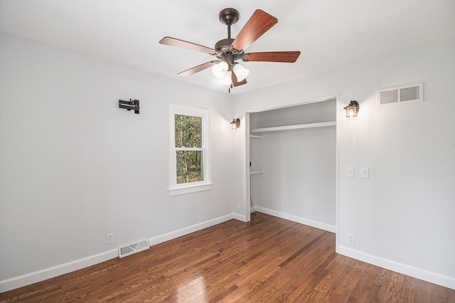 unfurnished bedroom featuring visible vents, baseboards, and wood finished floors