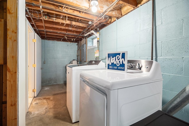 clothes washing area with washer and dryer, laundry area, and electric panel