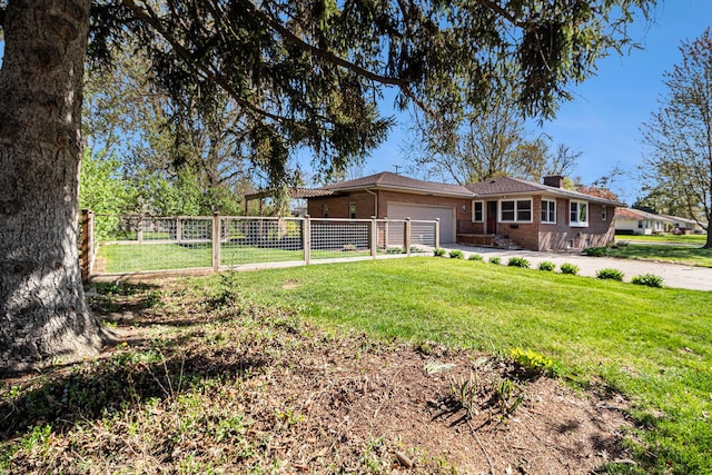 exterior space featuring a chimney, a lawn, brick siding, fence, and an attached garage