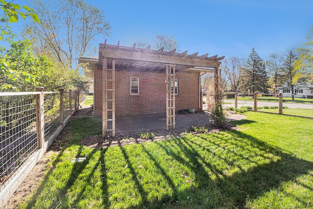 back of house featuring brick siding, a lawn, fence, and a pergola