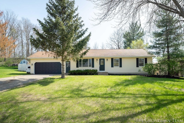 ranch-style house featuring an attached garage, driveway, and a front lawn