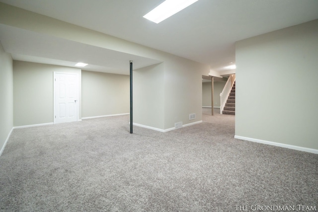 finished basement with carpet floors, baseboards, and stairs