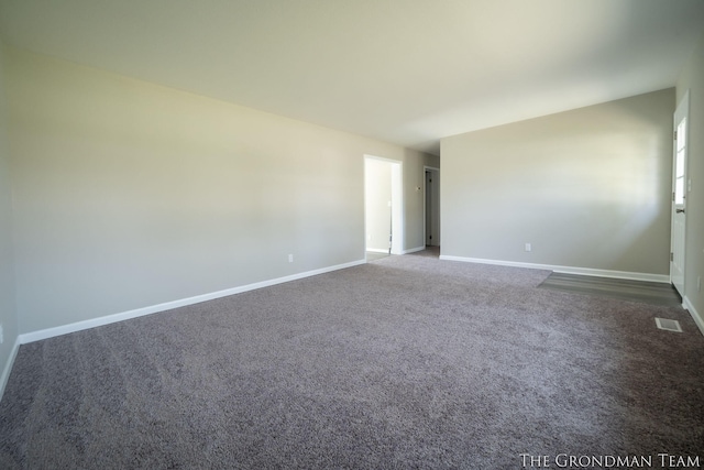carpeted empty room with baseboards and visible vents