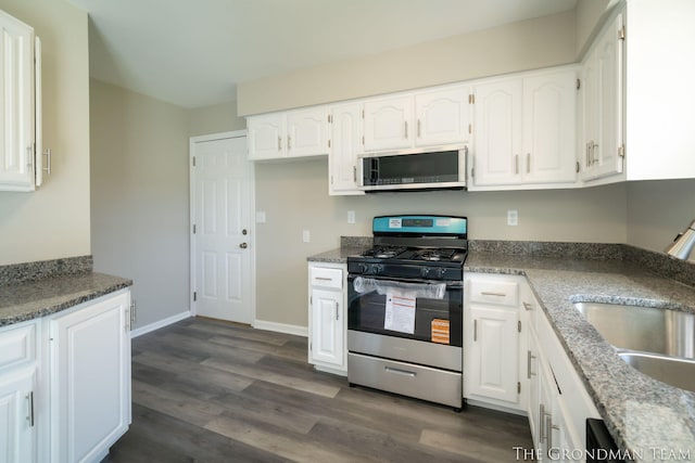 kitchen featuring a sink, dark wood-style floors, white cabinets, and stainless steel appliances