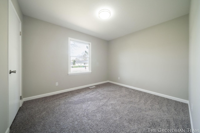 empty room with carpet floors and baseboards