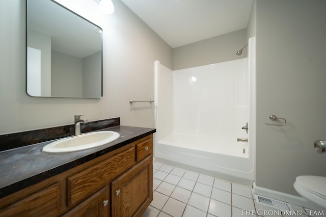 bathroom featuring vanity, visible vents, toilet, washtub / shower combination, and tile patterned floors